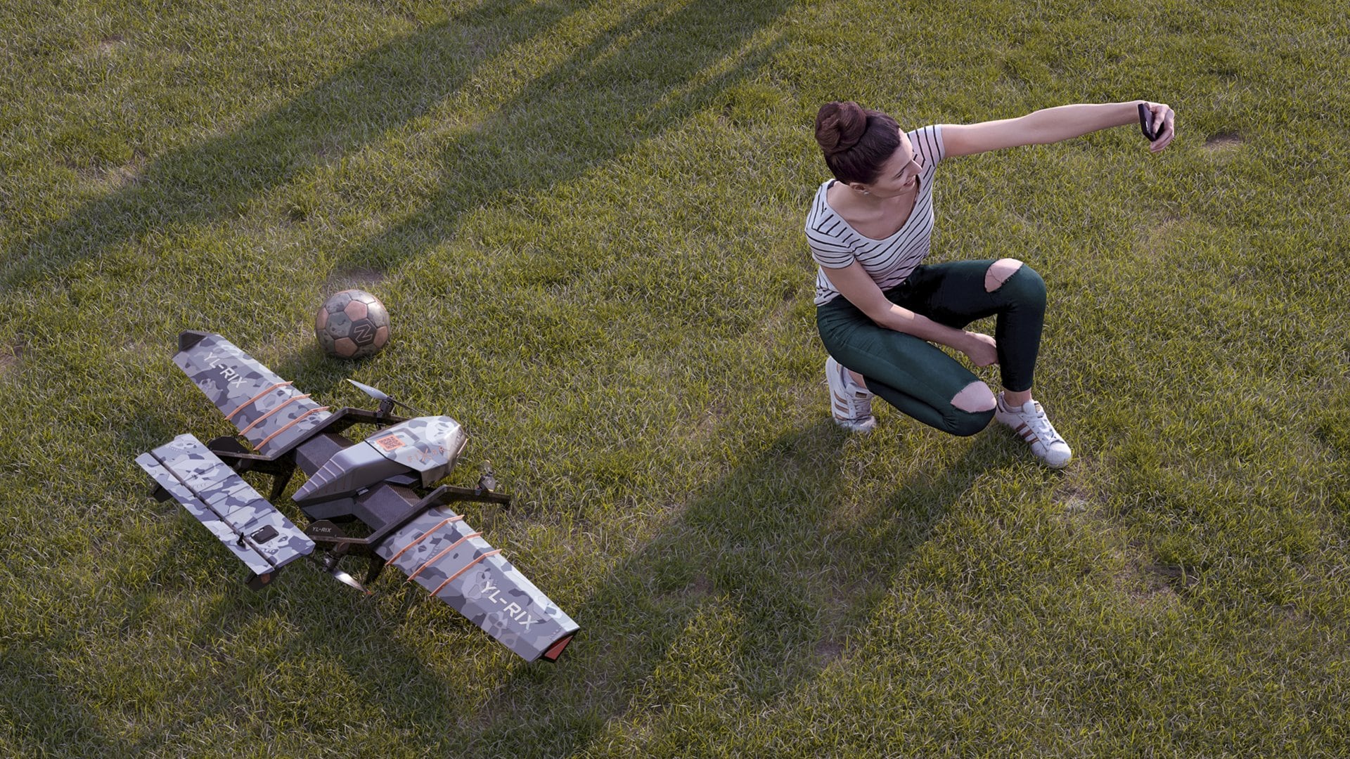 Woman kicking a football beside a grounded DARTZ PromDrone Black Bee