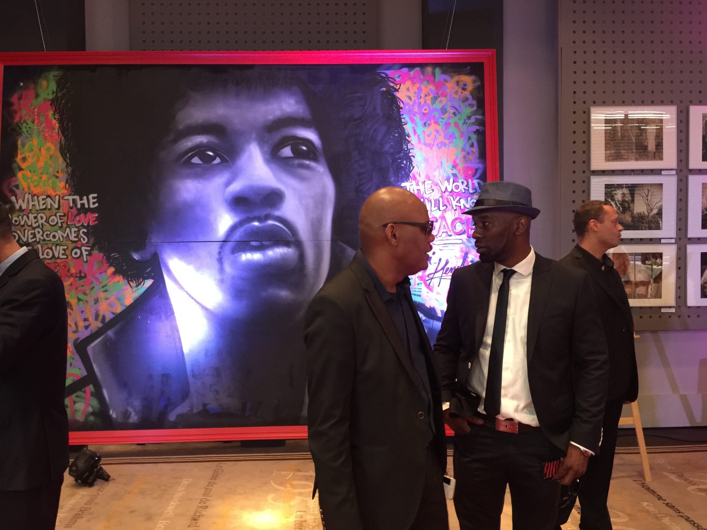 Guests before a large pop-art portrait at the Cannes Film Festival Auction 2015, Hôtel Barrière Le Majestic