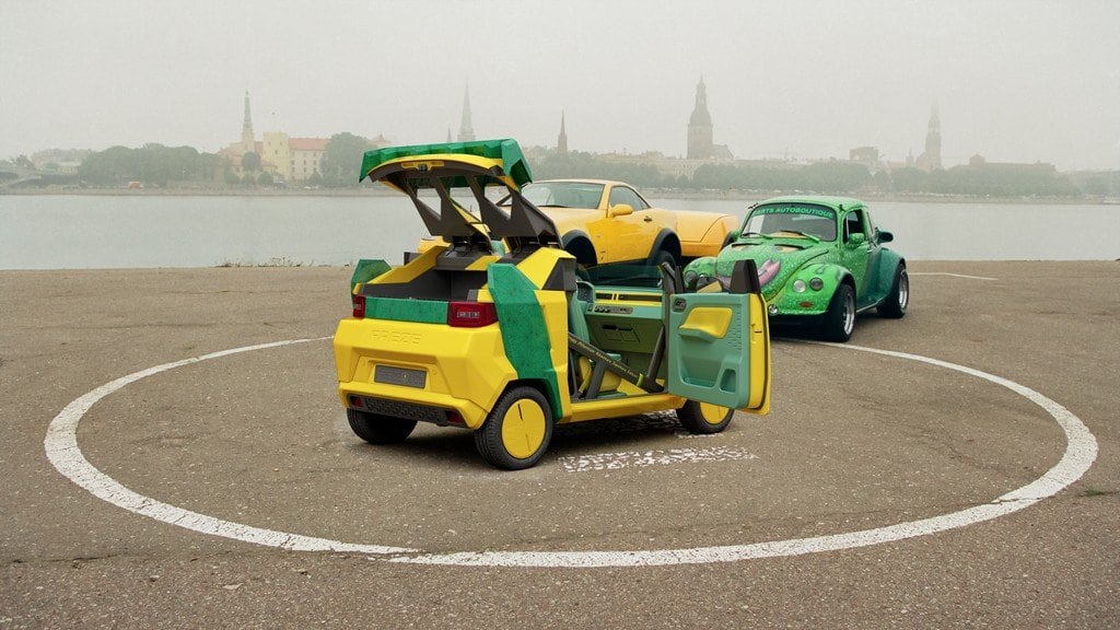 FreZe EV with doors and tailgate open, Riga Old Town spires behind