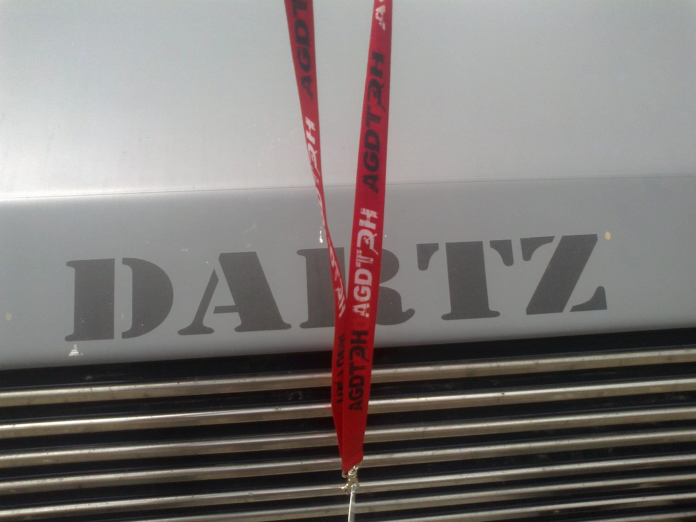 DARTZ lettering on a Prombron’ grille, with a red crew lanyard