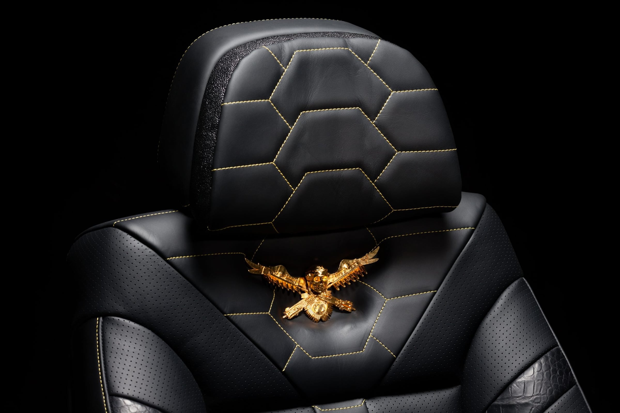Hexagon-quilted black leather DARTZ seat with a gold eagle crest