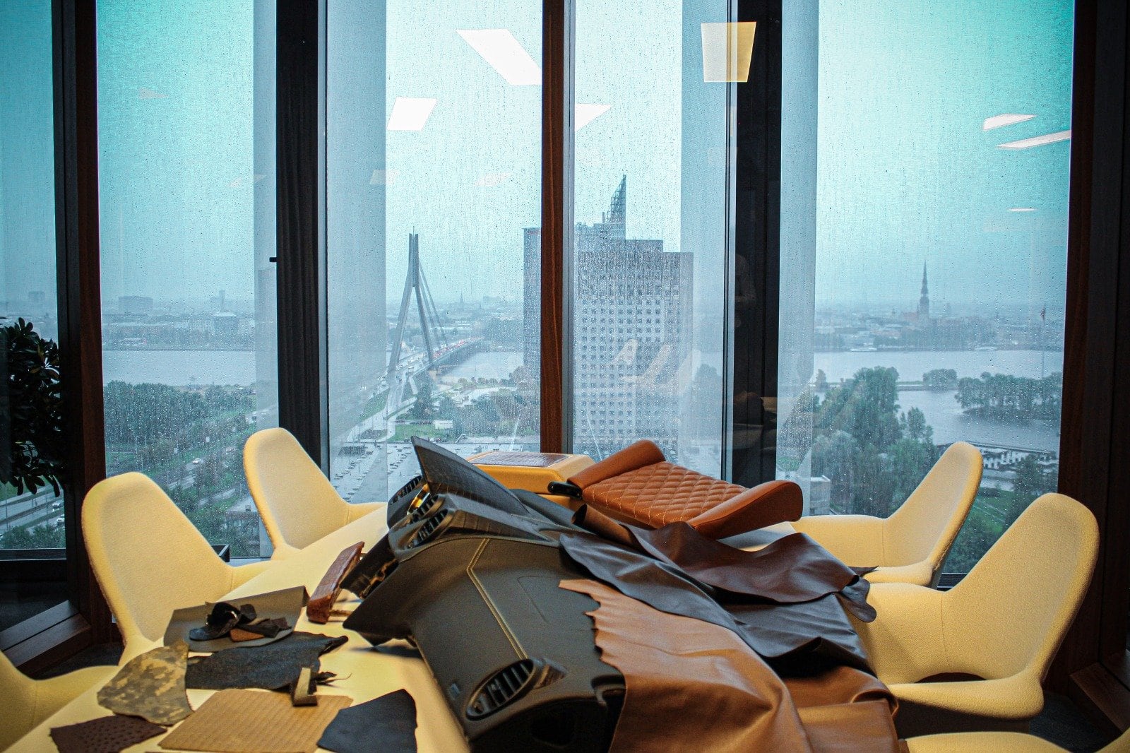 Leather hides and steering wheels laid out in the DARTZ studio, Riga