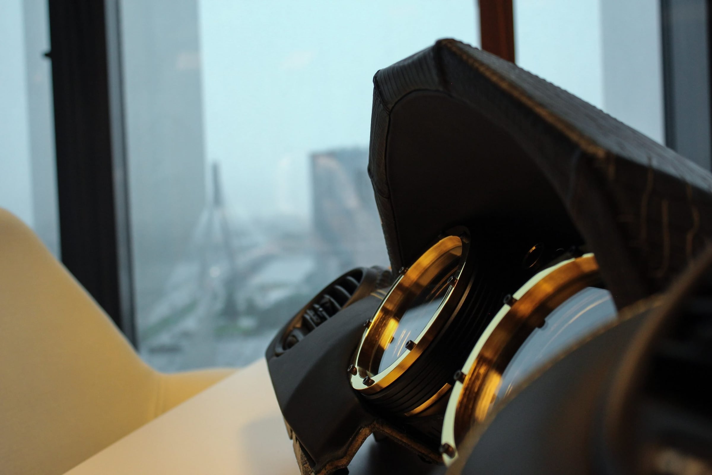 Crocodile-leather DARTZ dashboard with gold dials by a rainy window