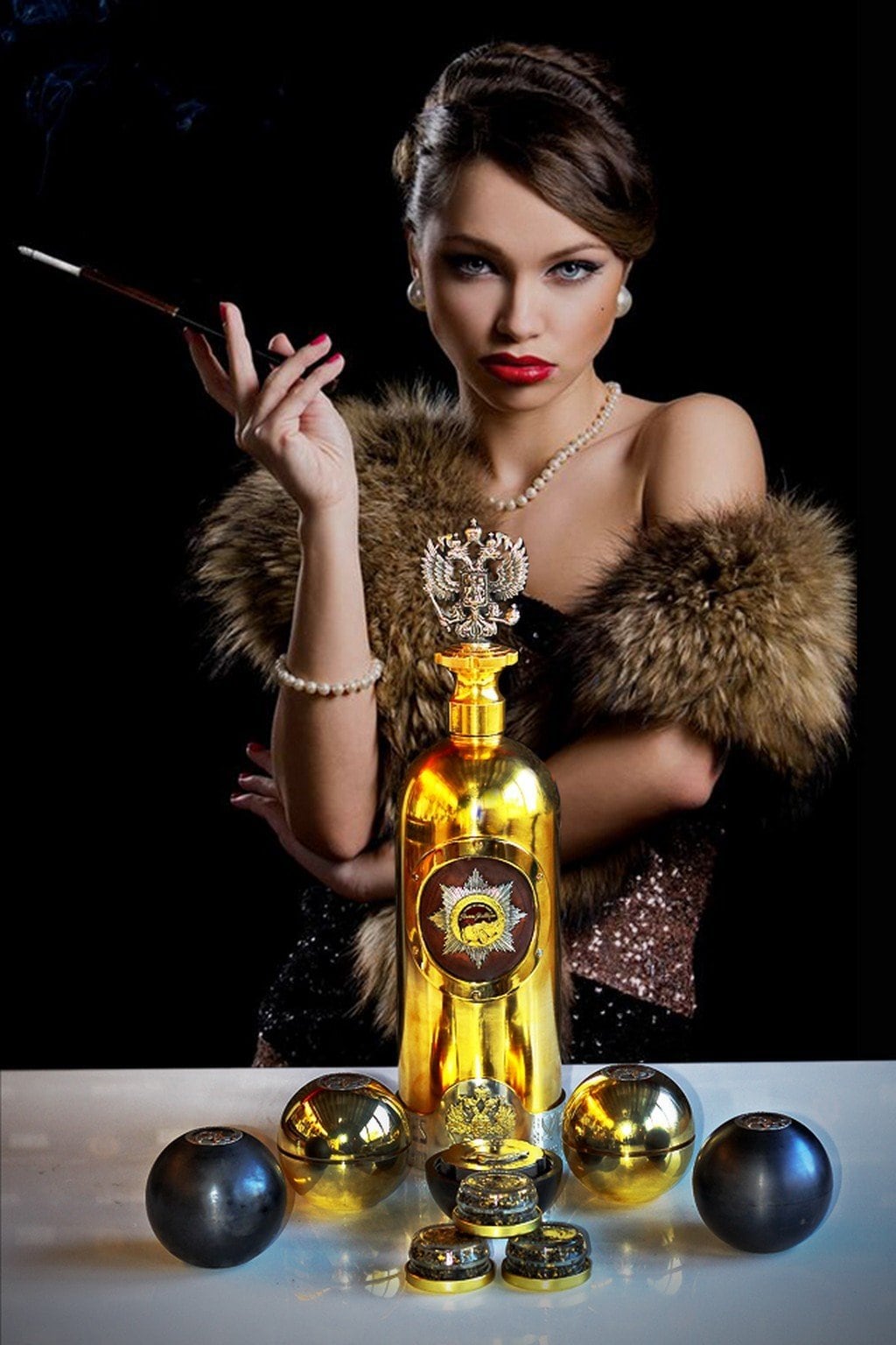 Gold DARTZ RussoBaltique vodka bottle with its double-headed-eagle stopper and caviar tins